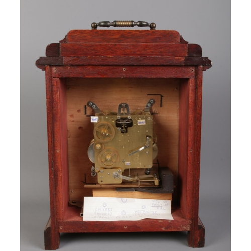 22 - A mahogany cased mantle clock with top bracket and Arabic numeral dial. Movement stamped for FHS, Ge... 