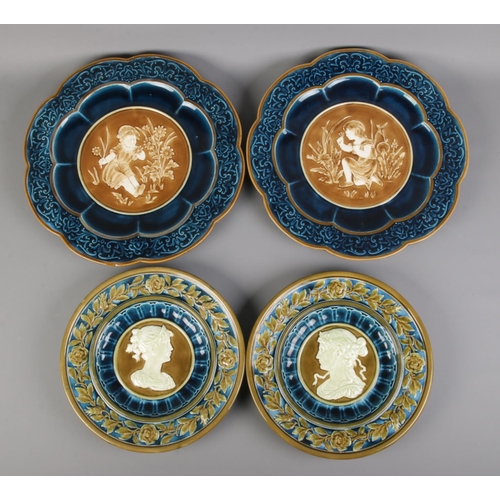 24 - Four Majolica style pottery chargers, impressed with backstamp 'Schutz'. Largest: 39cm.