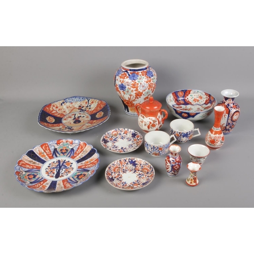 26 - A collection of oriental ceramics including Imari pattern vase, bowl, plates, etc.