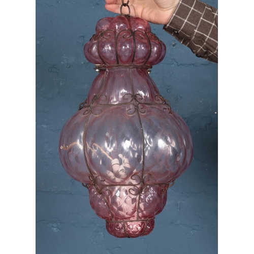 206 - A pink blown glass and wirework hanging light.