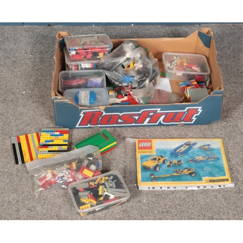 211 - A box of assorted Lego pieces, all loose, along with Lego vehicles designer set booklet.