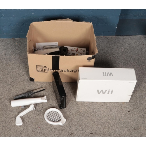 218 - Two Nintendo Wii games consoles, including one boxed, along with several joycon accessories.