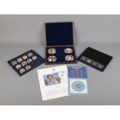30 - A collection of Westminster Collection and Windsor Mint coins and cases as well as other commemorati... 