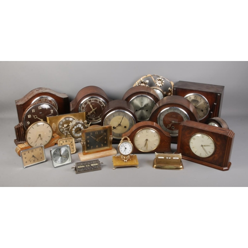 232 - A large collection of assorted clocks including several Smiths Enfield clocks.