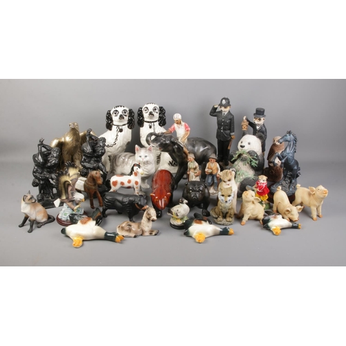 239 - A large collection of assorted pottery and resin figures