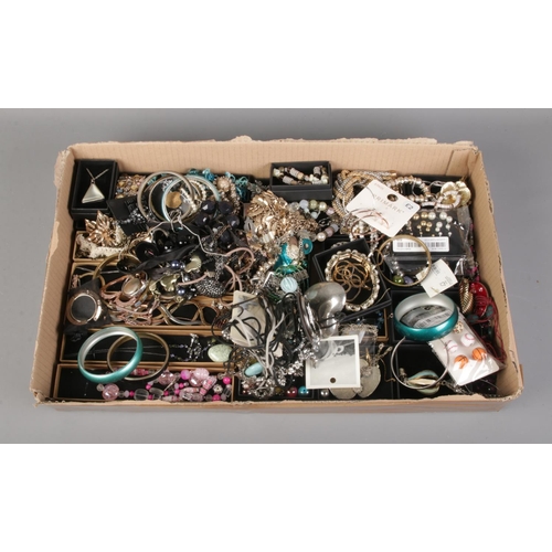 248 - A tray of assorted costume jewellery, with many boxed examples, including bangles, necklaces, earrin... 