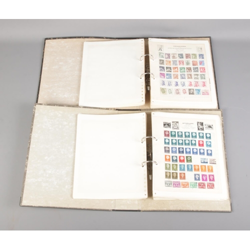 41 - Two albums of world stamps including German WWII examples, Indonesia, Poland, Great Britain, Canada,... 