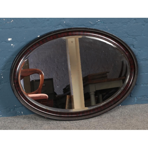 295 - A bevelled edge framed mirror 85cm width