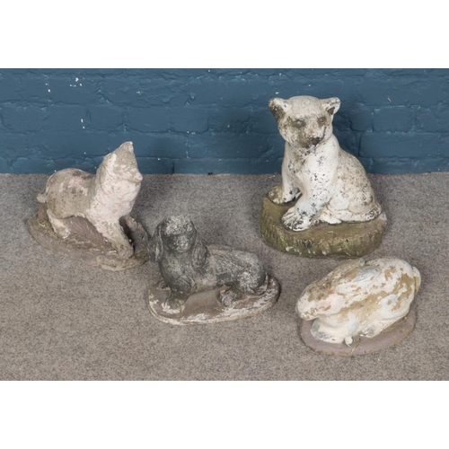 330 - A collection of four reconstituted stone animals including rabbit, lion cub and two dogs.