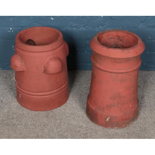 331 - A pair of terracotta chimney pots tallest at 48cm