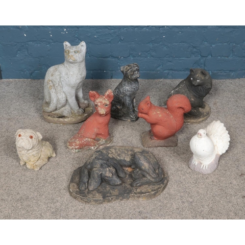 333 - A collection of eight reconstituted stone animals including dog, cat and dove