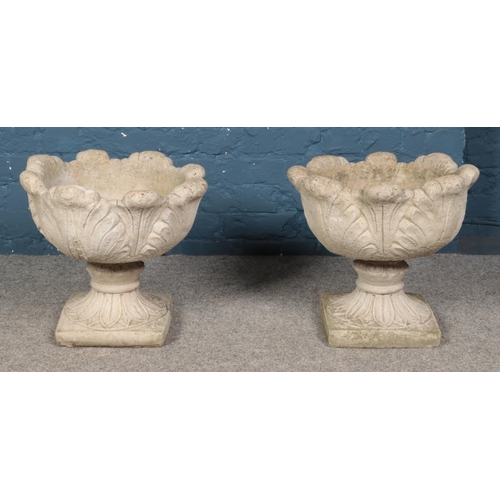 344 - A pair of circular concrete planters featuring leaf decoration. Approx. dimensions 46cm x 42cm.