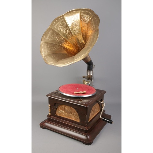 350 - A reproduction brass horned gramophone featuring decorative floral motifs.