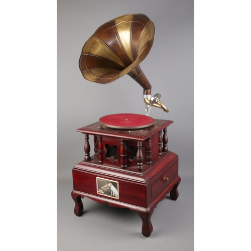 355 - A His Master's Voice reproduction gramophone with decorative base featuring singular drawer.