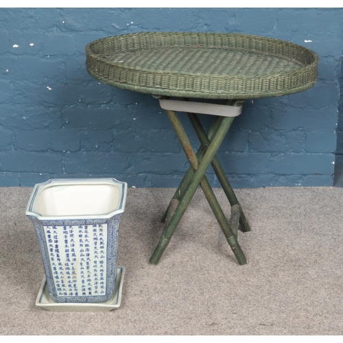 359 - An oriental style blue and white planter along with folding bamboo garden table.