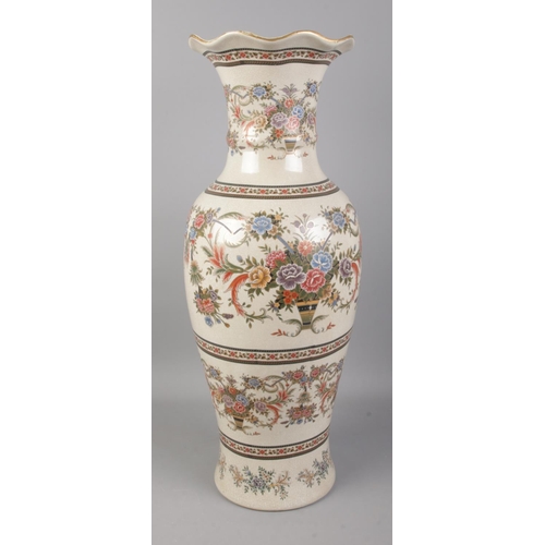 382 - A decorative ceramic floor vase decorated with floral motifs. Approx. height 80cm.