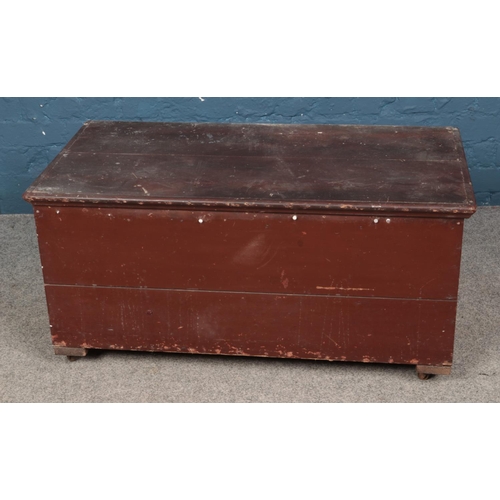 389 - A painted blanket box raised on castors. Approx. dimensions 95cm x 41cm x 47cm.