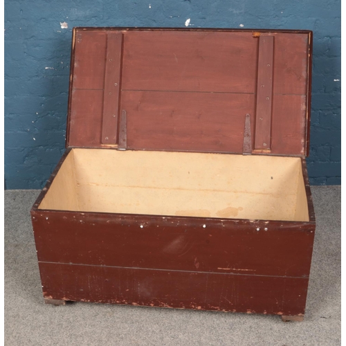 389 - A painted blanket box raised on castors. Approx. dimensions 95cm x 41cm x 47cm.