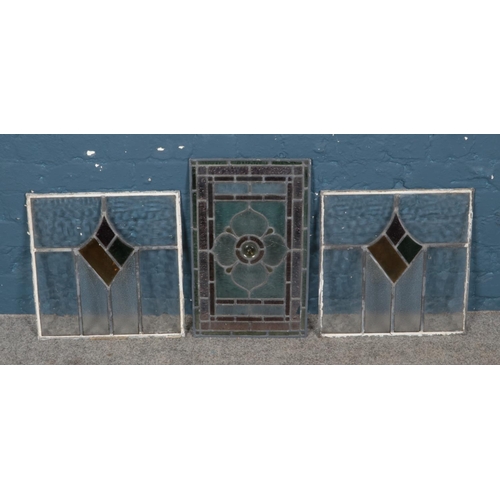 392 - A pair of leaded stained glass windows along with a single example. Single pane 52cm x 33cm. Pair 42... 