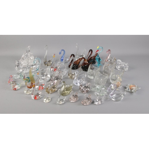 68 - A large collection of glass swans and other glass figures of animals.