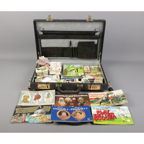 69 - A suitcase containing a good collection of cigarette and tea cards; loose and in books. Containing B... 