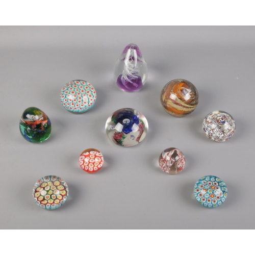 70 - A collection of glass paperweights, ten in total.