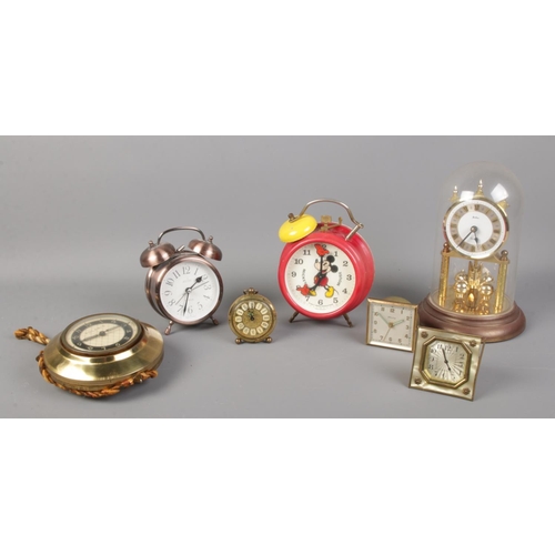 79 - An assortment of mantle and alarm clocks, to include torsion and Bradley Mickey mouse alarm examples... 