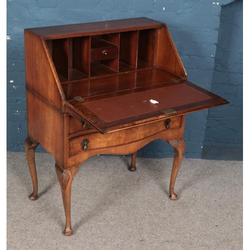 508 - A walnut bureau with two drawers and cabriole feet. Complete with key and brown leather writing rest... 