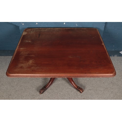 515 - Large rectangular mahogany dining table on a turned column support and scrolling quadruple splay bas... 