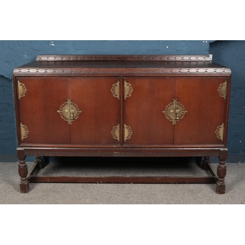 559 - 1930's oak oriental style sideboard with brass escutcheons