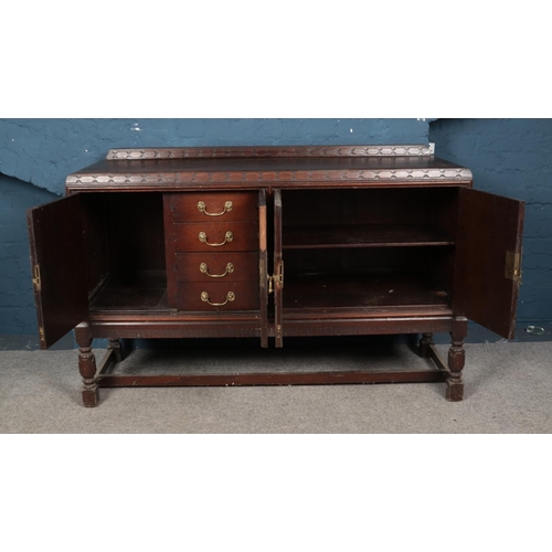 559 - 1930's oak oriental style sideboard with brass escutcheons