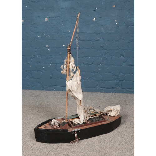 403 - A wooden model of boat for repair. Length 63cm.