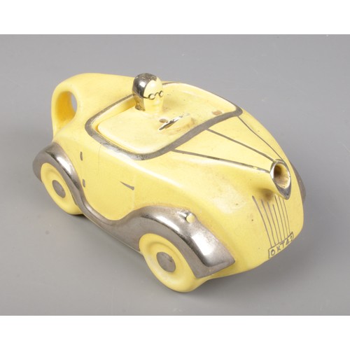 131 - An Art Deco Sadler novelty racing car teapot in yellow with chrome detailing. Number plate OKT42. Le... 