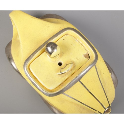 131 - An Art Deco Sadler novelty racing car teapot in yellow with chrome detailing. Number plate OKT42. Le... 