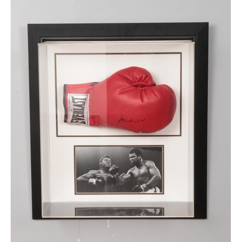 249 - A Muhammed Ali signed boxing glove in presentation case. Approx. case dimensions 51cm x 57cm x 19cm.