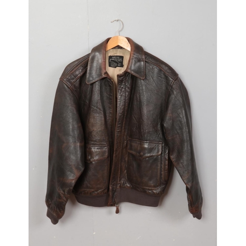 226 - A reproduction Avirex Type A-2 US Air Force leather bomber jacket decorated with military aircraft t... 