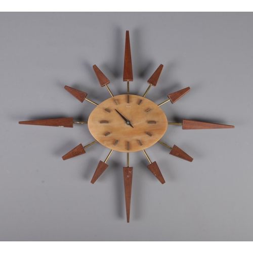 240 - A Manley sunburst quartz wall clock.