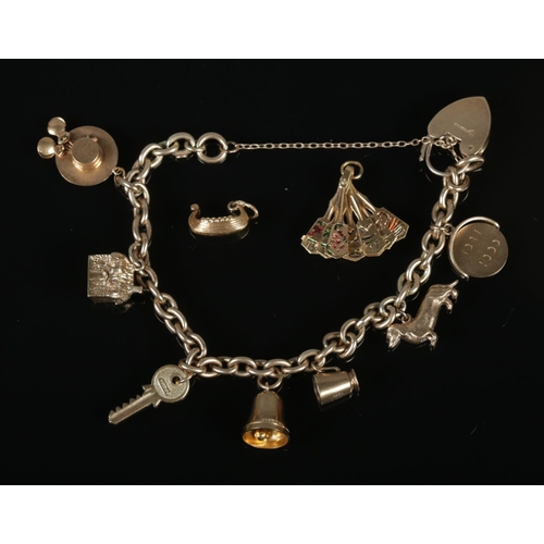 287 - A 9ct gold charm bracelet with mostly 9ct gold charms. 28.2g