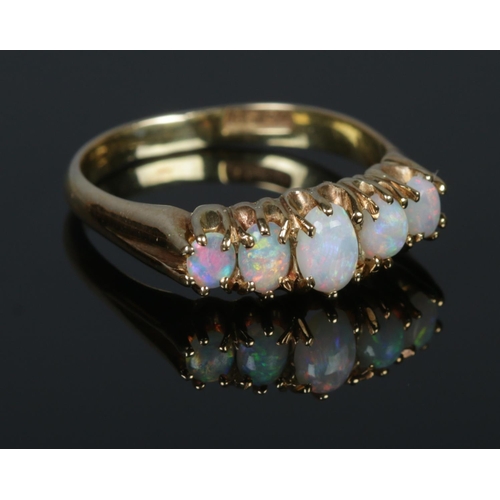 300 - A Victorian Gold and five stone Opal ring, stamped 15ct to the inside of the band. Size Q. Total wei... 