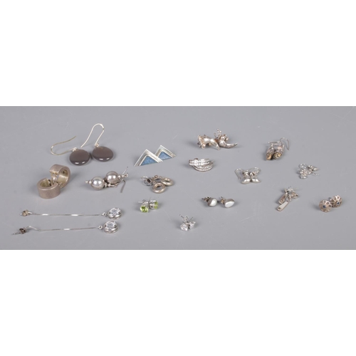 338 - Sixteen pairs of silver earrings, to include studs, droplet and large polished stone examples. Total... 