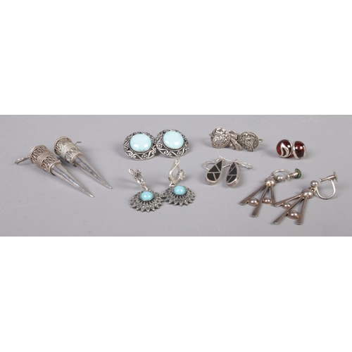 340 - Seven pairs of silver earrings, to include large pointed and turquoise set examples. Total weight: 4... 