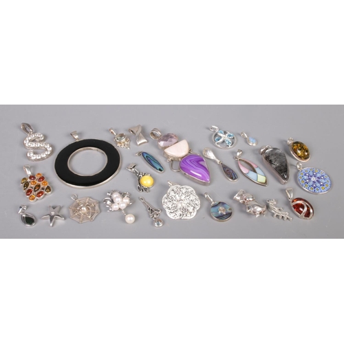 342 - Twenty-five silver pendants, to include wirework, amber coloured, abalone and millefleur examples. T... 