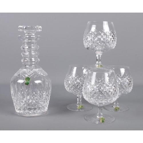 366 - A Waterford crystal 'three ring' decanter, together with four Waterford crystal brandy glasses.