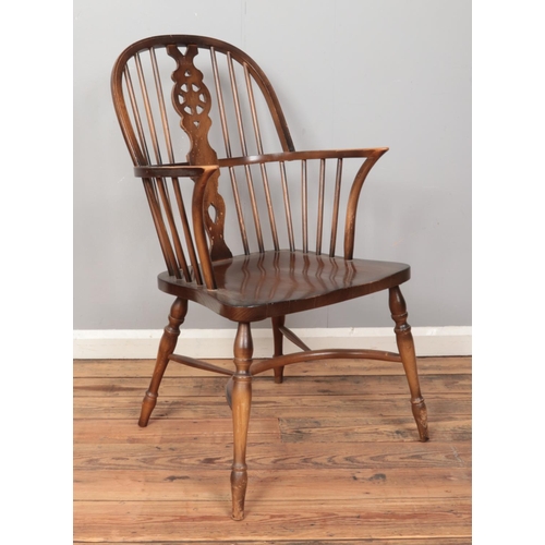 408 - A ash/elm Windsor armchair, with crinoline stretcher and wheelback splat.