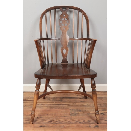 408 - A ash/elm Windsor armchair, with crinoline stretcher and wheelback splat.