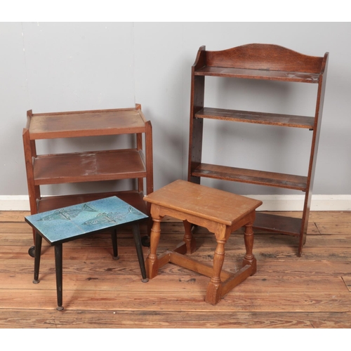 409 - A quantity of assorted furniture to include hostess trolley, open bookcase, tile top table, etc.