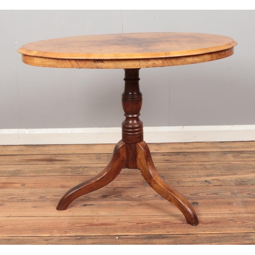 411 - A walnut topped window table, on turned oak column and tripod base, with inlay decoration. Diameter ... 