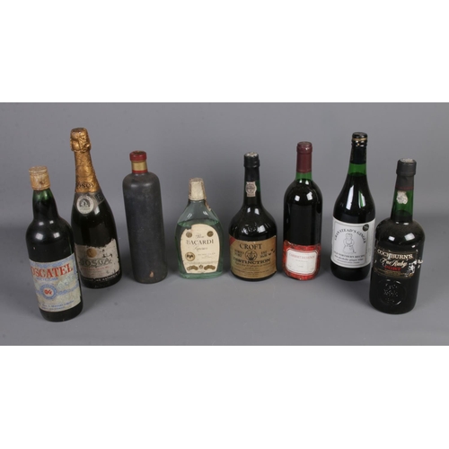 107 - A collection of vintage alcohol including Cockburn's Fine Ruby Port, Moscatel Capital Wine, Cabernet... 