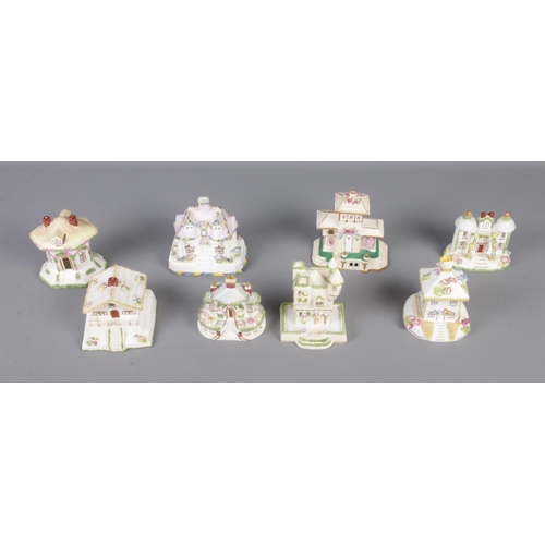 23 - A collection of eight Coalport ceramic cottages including The Country Cottage, Jyrolean Castle, Swis... 