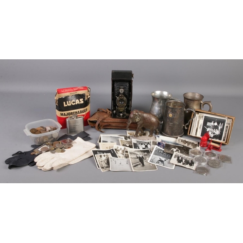 166 - A large assortment of collectables, to include pewter tankards, 2A Brownie camera, vintage photograp... 